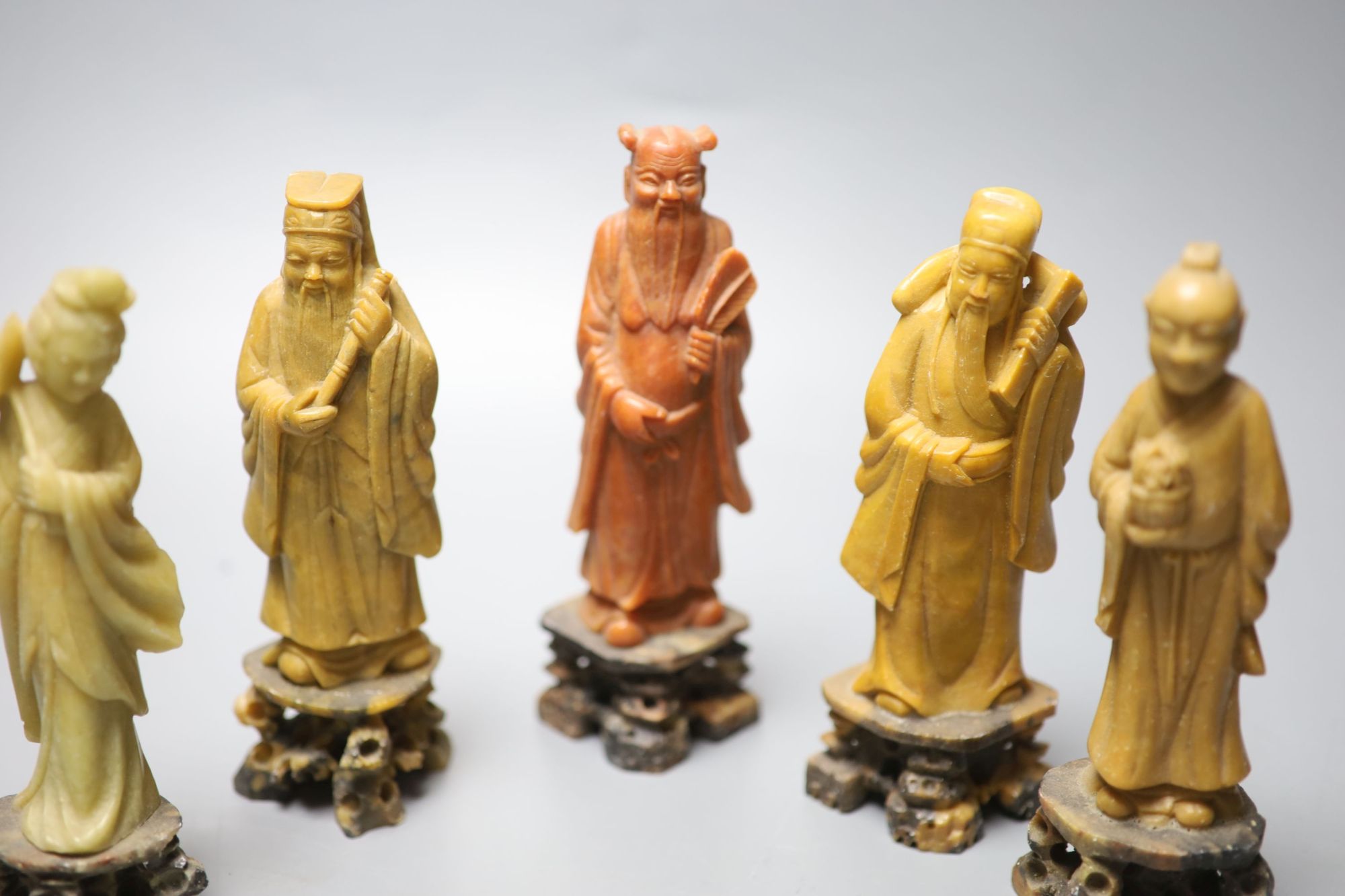 A set of soapstone carvings of the Eight Immortals, early 20th century, in varied colour of stone, height 16cm